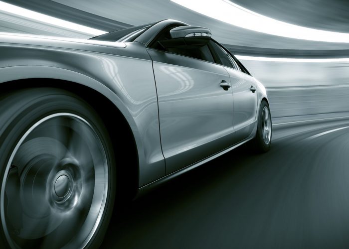12905017 - 3d rendering of a brandless generic car of my own design in a tunnel with heavy motion blur